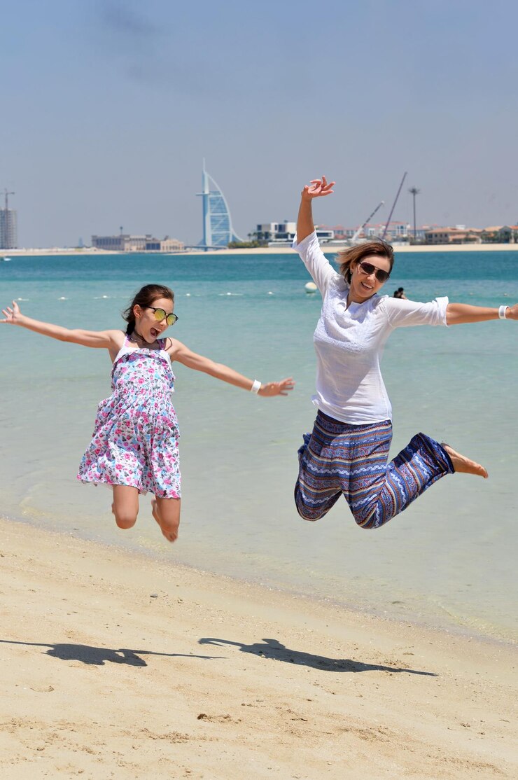 happy-mother-with-daughter-jumping-beach_484921-96246